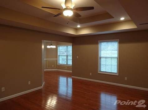 The great room leads into the breakfast nook with a bay window.