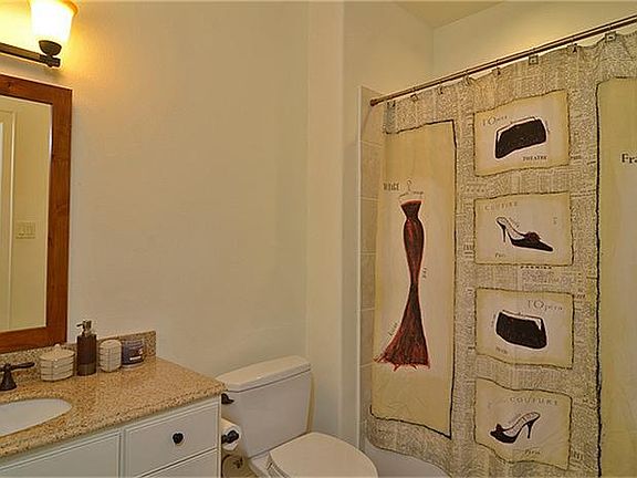 First floor full bathroom with granite counter tops and shower