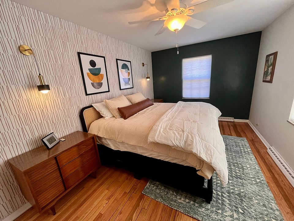 Primary Bedroom has King Bed. Remote controlled rechargeable sconce lighting. Two large nightstands that can fit all your clothes. Ceiling fan. Clock. Large mirror