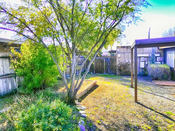 Large private fenced backyard with porch.