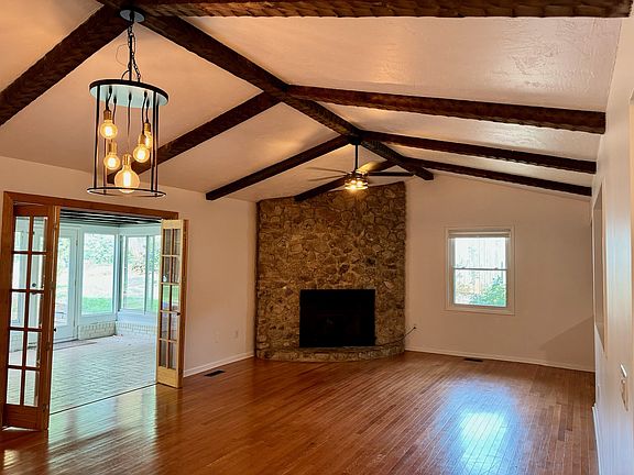 Great room with living and dining area, opening to the sunroom with access to the fully fenced backyard
