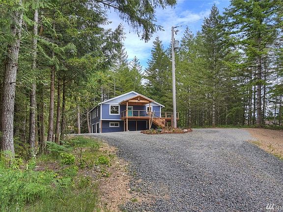 Perched high, secluded and surrounded by green beauty! Great family history on this property - son built this new home on his dad's land - where dad had previously built his home.