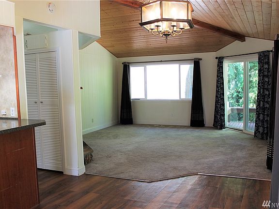 From the front door looking into the dining and living room area. Kitchen is to the left, as is the hallway to the bedrooms.
