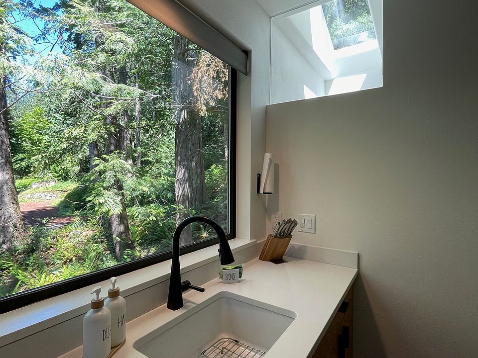 Beautiful woods right outside the kitchen window and interior window to bring in light from the bathroom skylight.