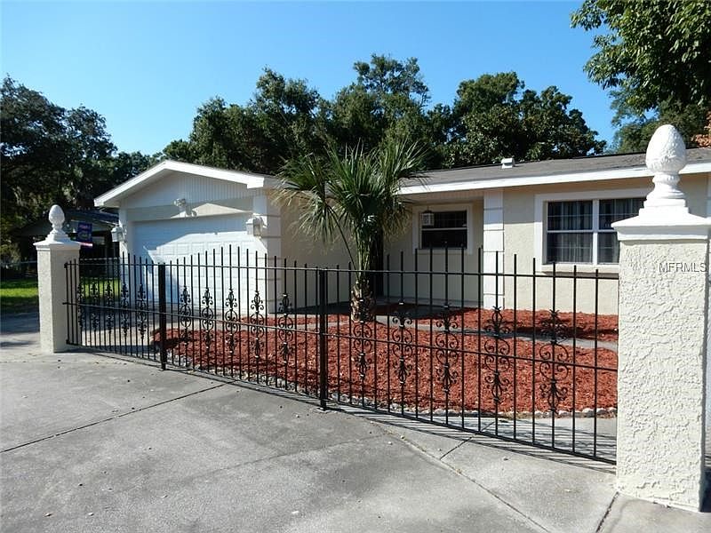 Front view with circular drive and 2 car garage