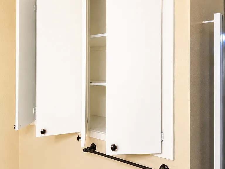 Bathroom includes built-in medicine cabinet/storage for added convenience.