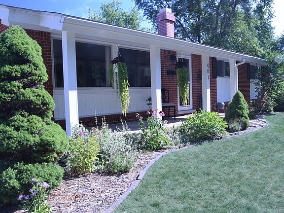 Beautiful landscaping along the entry, including a large porch.