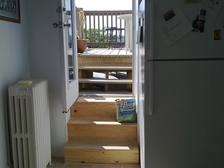 The exterior glass door to the deck allow natural light into the kitchen.
