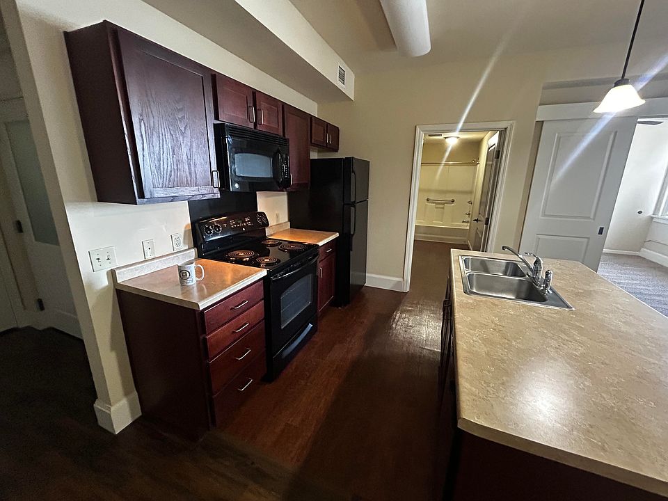 Kitchen area complete with refrigerator, stove, microwave, dishwasher