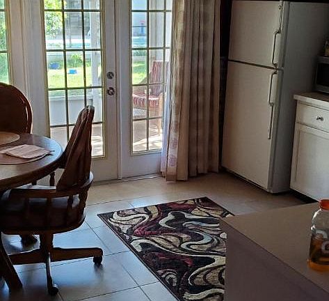 kitchen with triple french doors to screened and solid roof covered patio