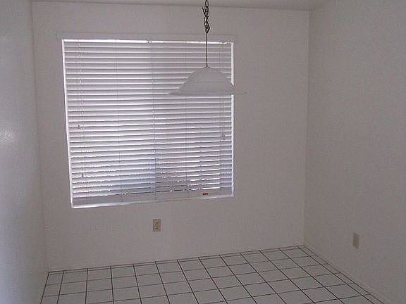 Breakfast nook with large window to porch and garden.