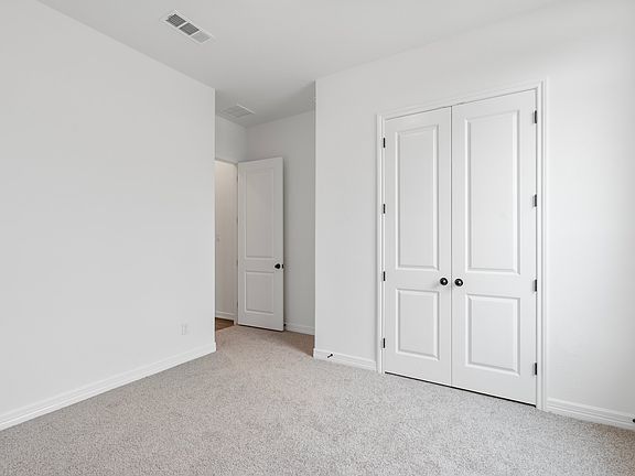 An additional view of the second bedroom and closet.