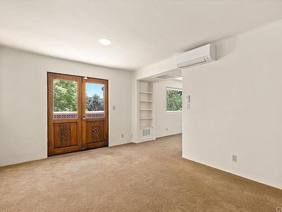 Second room of upstairs apartment. French doors open to private terrace.