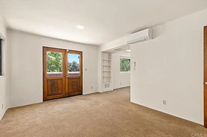 Second room of upstairs apartment. French doors open to private terrace.