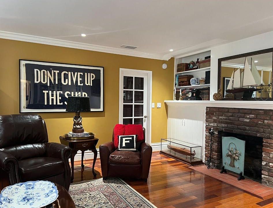 Living room with original brick fireplace with gas logs