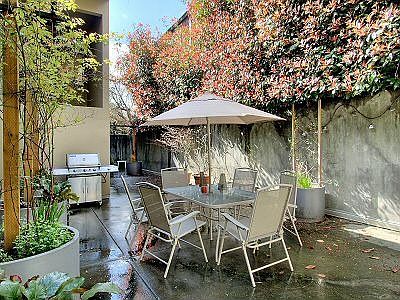 Public patio in back with grill and table