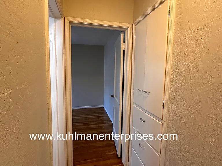 Hallway linen storage near bathroom and bedrooms