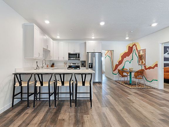 View of countertop dining, dining area + kitchen, all furniture included.