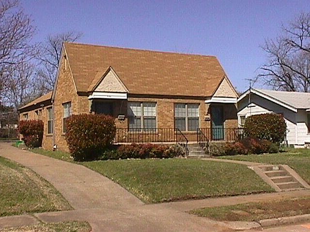 Front View. Side Drive leads to parking pad for off street parking.