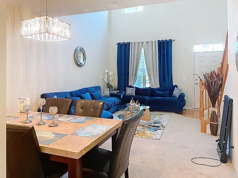 View at the the living room and front entrance from the dining area