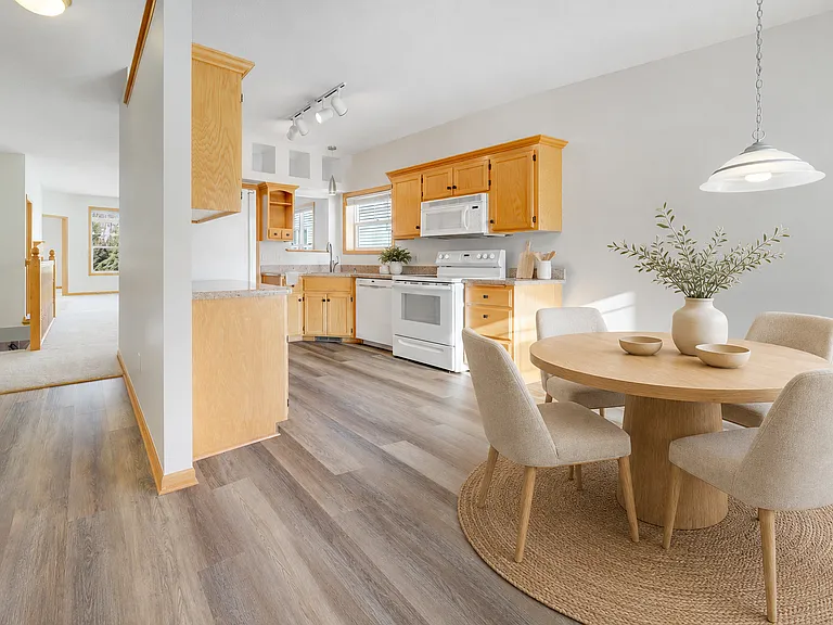 Bright galley kitchen with informal dining area.