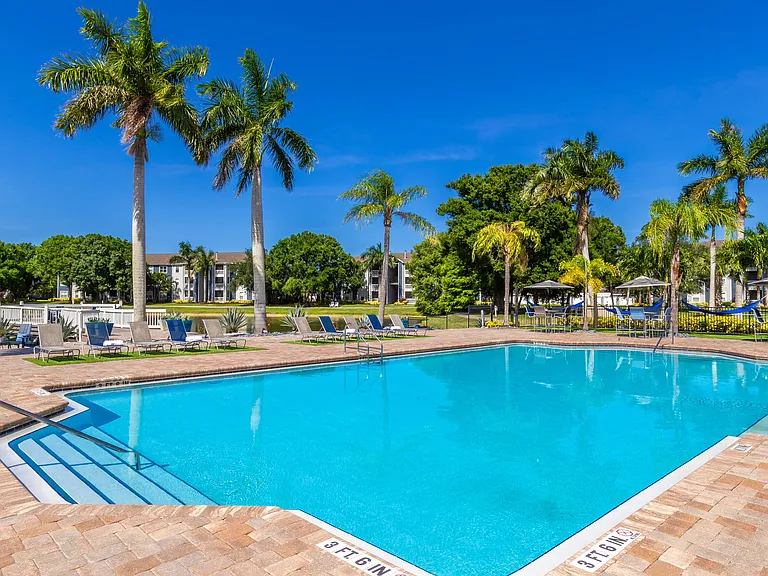 Bask under the Florida sun at our sparkling resort-style pool, surrounded by swaying palms, comfortable loungers, and breathtaking lake views.