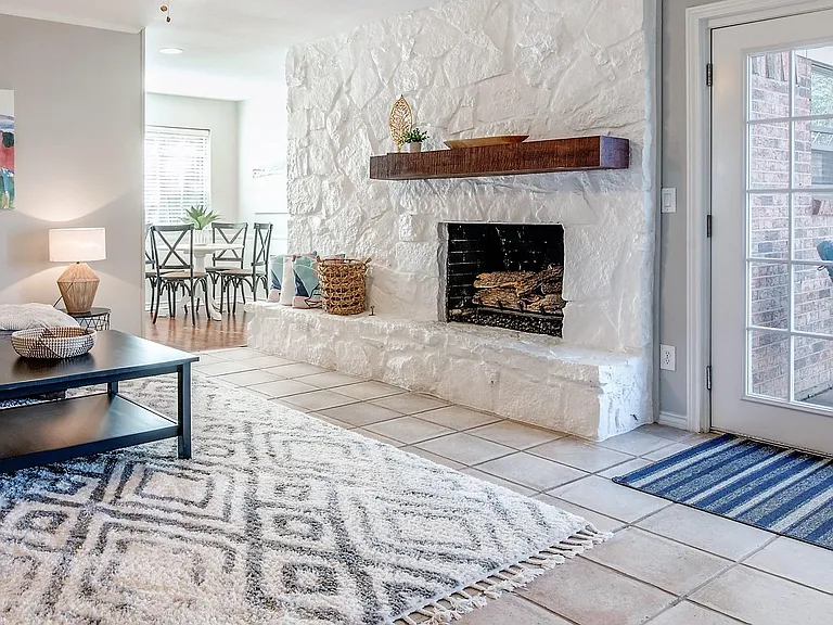 Stone Floor to Ceiling Gas Log Fireplace. French Doors leading to the backyard.