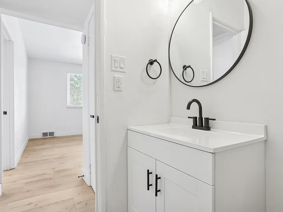 Exceptionally remodeled bathroom with two tone tile, sliding shower glass doors, no more shower curtains, new tub, bathroom vanity, light fixtures and towel hooks