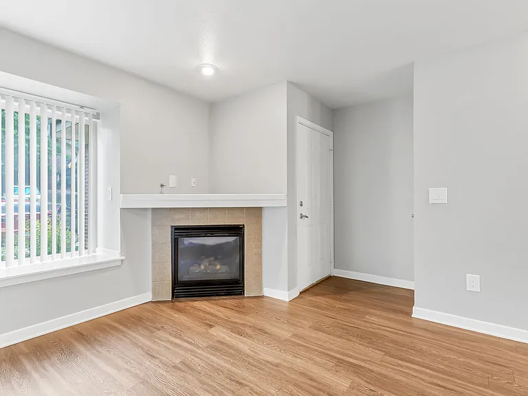 A Living Room with a Fireplace at The Buttes Apartment Homes in Loveland, CO