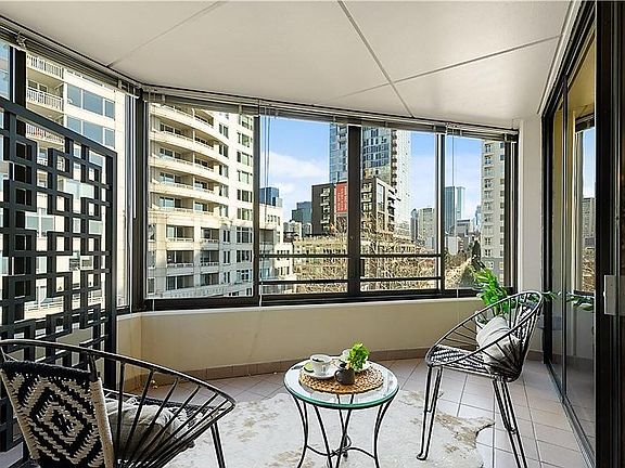 Spacious enclosed patio with glass sliding doors to living area and bedroom.