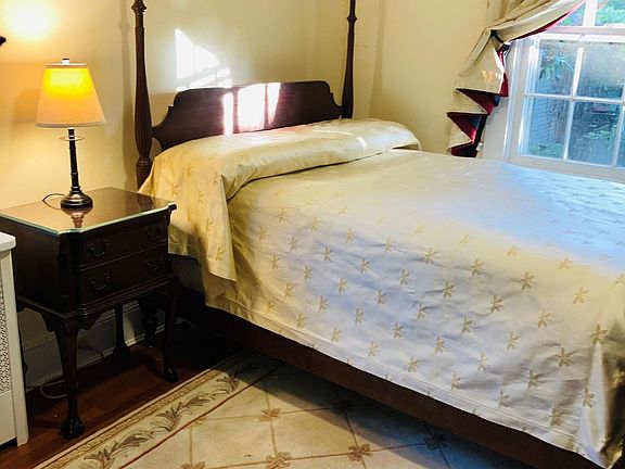 Back bedroom with queen bed, mahogany dresser and end table, one closet, WiFi tv