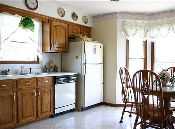 Kitchen is trimmed with beautiful oak cabinents and features eat-in area.