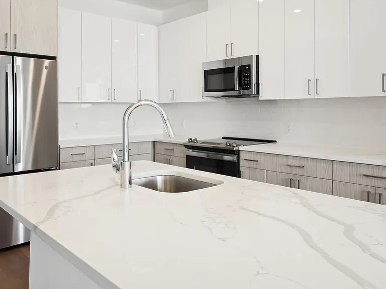 Kitchen with Stainless Steel Appliances and White Granite Countertops