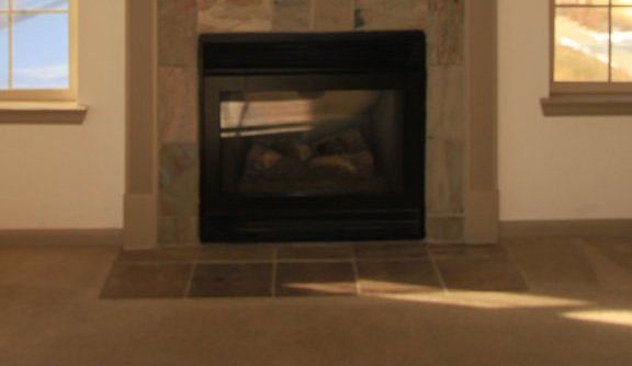 Gas fireplace in light and bright living room.