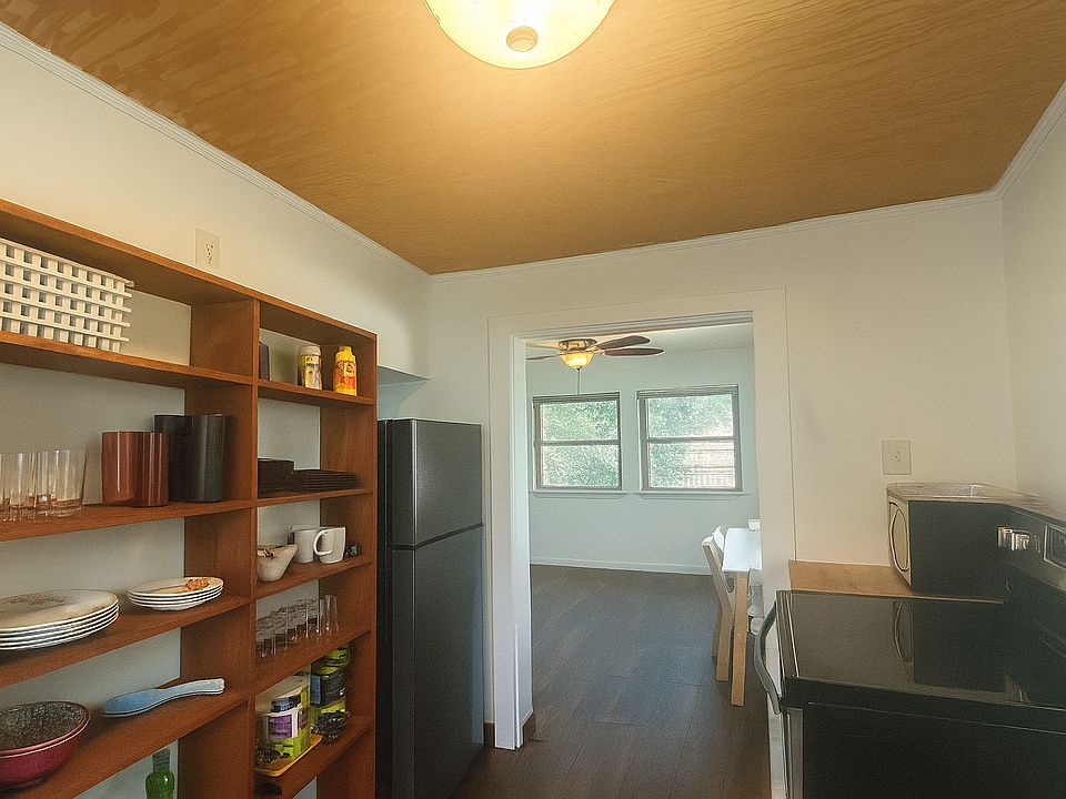 Furnished kitchen with fridge, freezer, stove, oven, microwave, plates, cups and bowls!