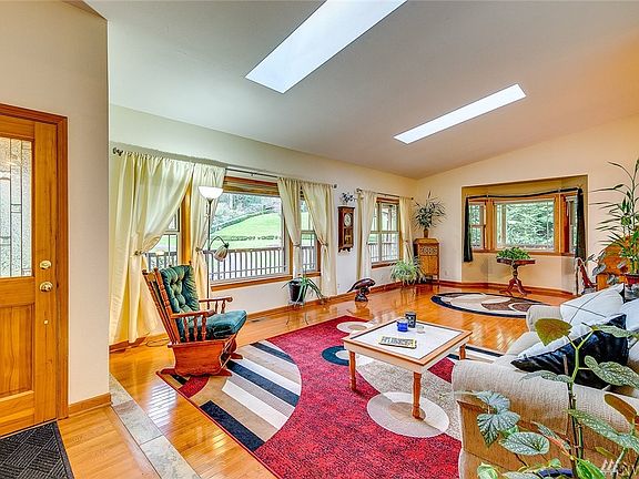 The foyer floor is oak.  The fabulous over-sized living room boasts of wood wrapped windows, cherry floors and skylights.  What 