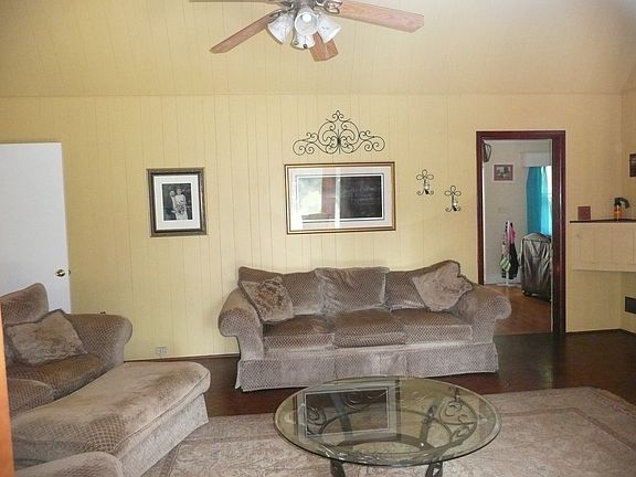 family room with vaulted ceiling and gas log fire place