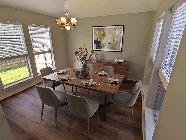 An AI image showing the Dining Room as it might be furnished. The AI table and chairs make the room look smaller than it is. Actual dimensions are 15 x 16'.