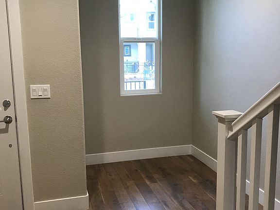 On the left is the entrance door and a recess area for a computer desk.