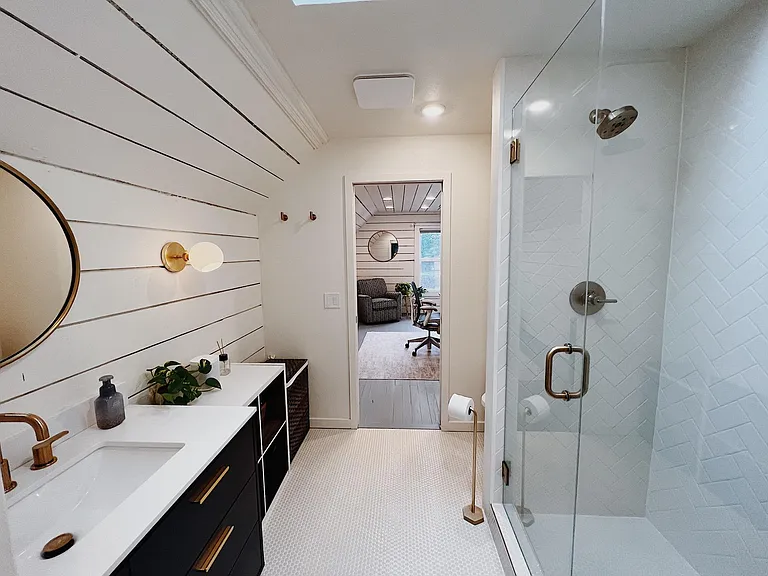 Upstairs bathroom (separates bedroom with primary closet / primary bedroom)