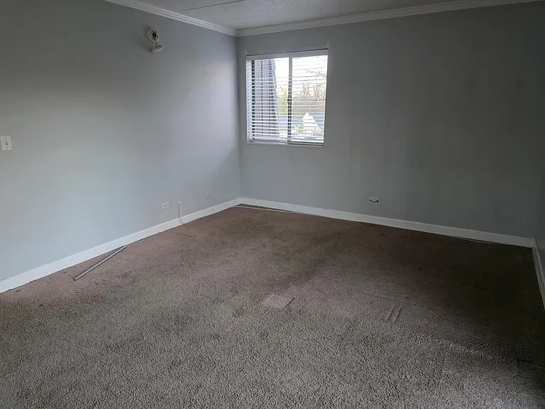 Master bedroom with window in addition to French door.