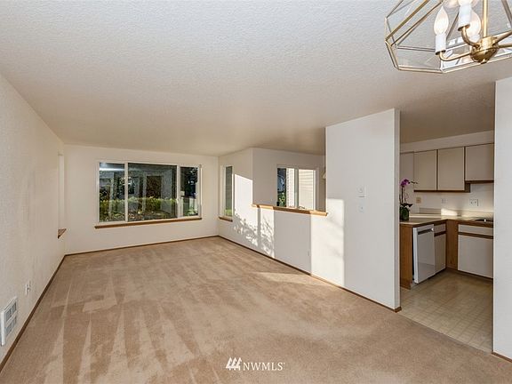 Living and dining rooms face west and look into garden. Gas fireplace can be added. Check with HOA for rules. 