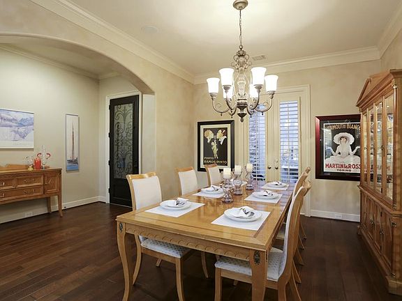 Elegant formal dining room with comfortable seating for 8 or more, natural light and open flow to kitchen and formal living area