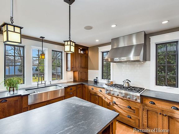 Beautiful backyard views from a farmhouse style stainless sink; Pendant & Recessed lighting, subway 