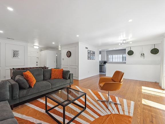 Spacious living room with 65" Roku TV and indoor fireplace