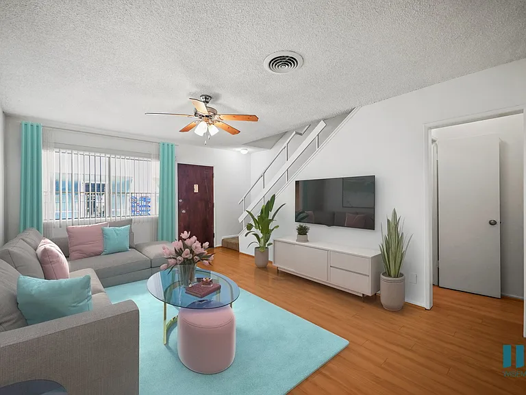 Entryway and Living Room with a Stairwell to the Upper Level of a Townhome