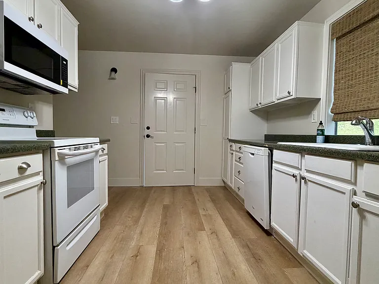 Kitchen with stove-oven combo, dishwasher, and microwave