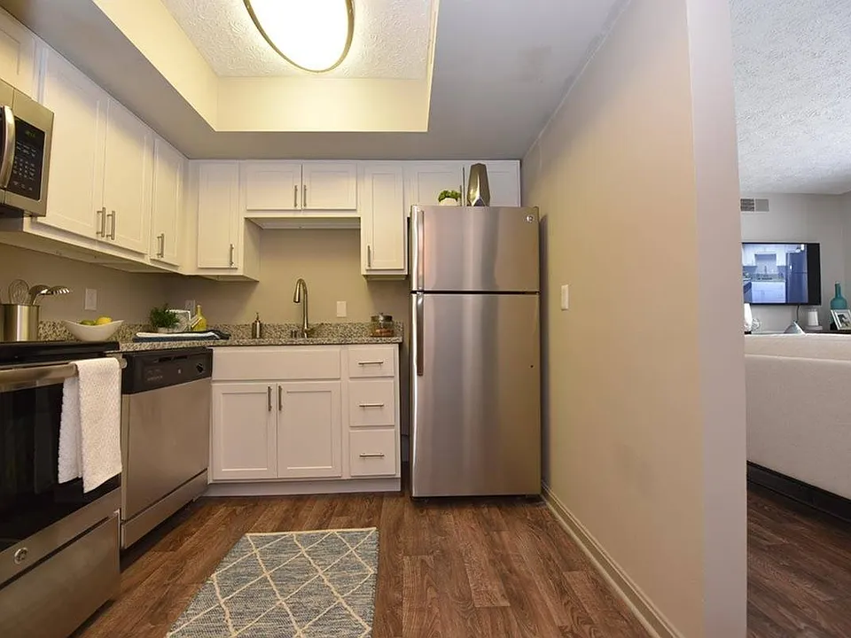 Kitchen with stainless steel appliances, modern cabinetry, and hardwood-style flooring