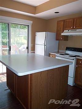 Kitchen with double doors leading to deck and back yard