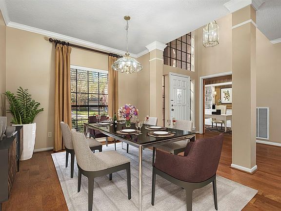 Immediately to the left of the front door is this spacious formal dining room which has been virtually staged. Also shown on the right is the private home office.